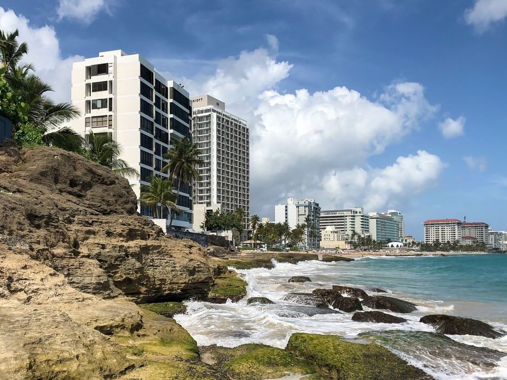 white and black concrete buildings under blue sky at daytime